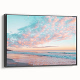 Framed canvas artwork depicting a serene beach landscape with vibrant colors and a black frame, showcasing tranquil waves and a sunset sky, ideal for home decor.