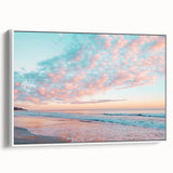 Framed canvas artwork showcasing a serene beach landscape with vibrant colors, displayed in a white frame, perfect for enhancing coastal-themed decor.