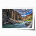 Vibrant landscape print showcasing majestic canyons in rich earth tones, elegantly rolled for easy display; perfect for enhancing home decor.