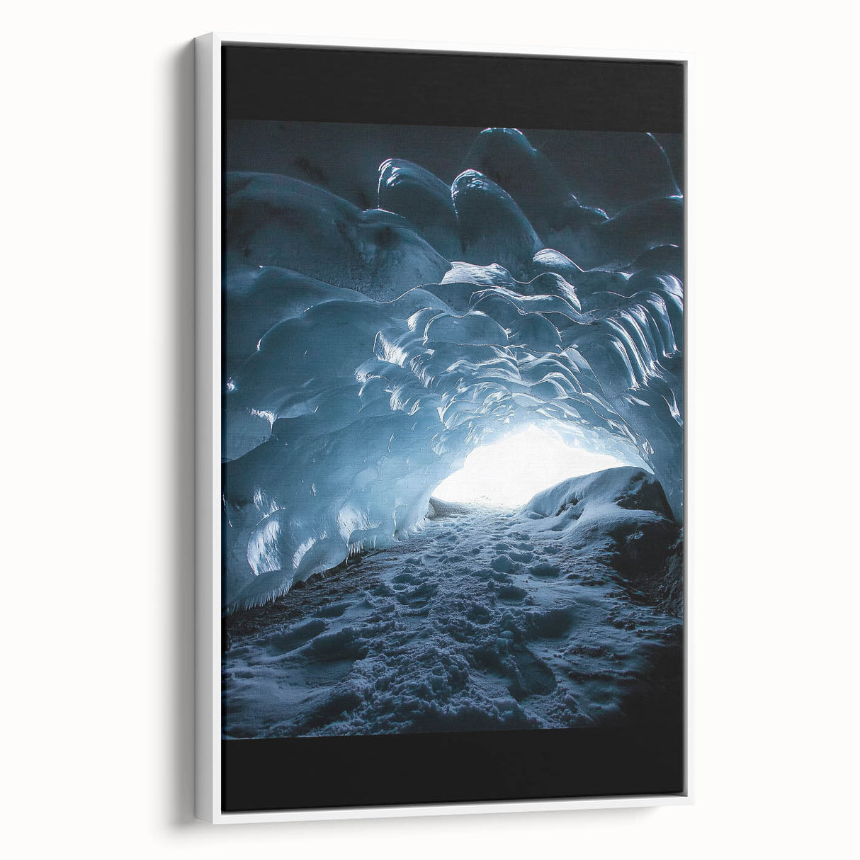 Framed canvas artwork showcasing a stunning landscape of caves, presented from a side view with a sleek white frame, perfect for modern home decor.