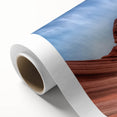 Landscape wall art on rolled canvas depicting vibrant canyons under a blue sky, showcasing earthy tones and textures, ideal for home decor. Perfect for nature enthusiasts.