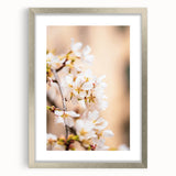 Textured art depicting abstract spring themes in soft green and pink hues, framed in silver, ideal for bedroom decor.