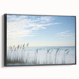 Framed landscape canvas depicting a serene beach scene, showcasing soft pastel colors and gentle waves, with a sleek black frame enhancing its modern aesthetic. Perfect for coastal decor enthusiasts.