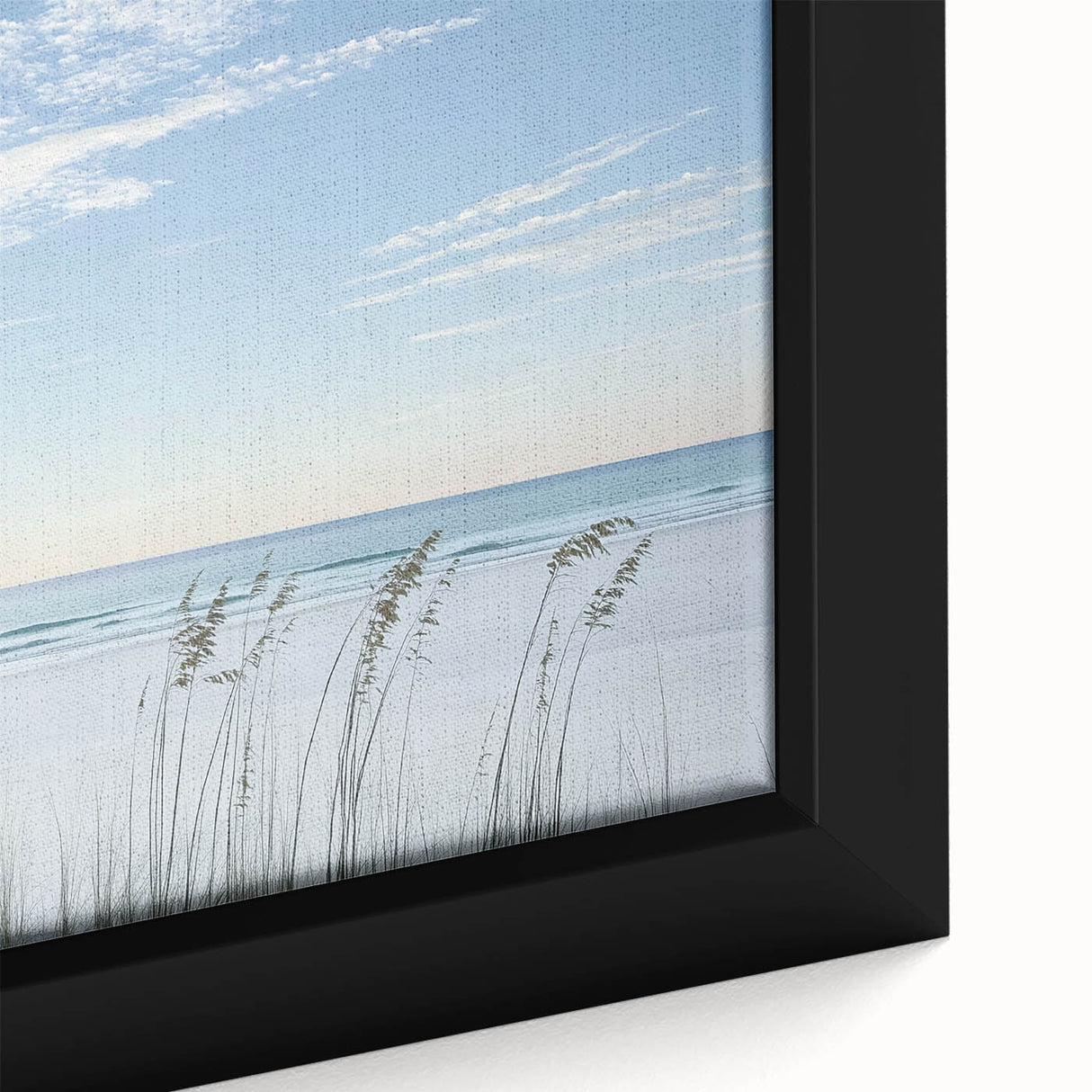 Close-up of a framed canvas depicting a serene beach landscape, showcasing gentle waves, soft sandy shores, and vibrant sunset colors, perfect for coastal decor.