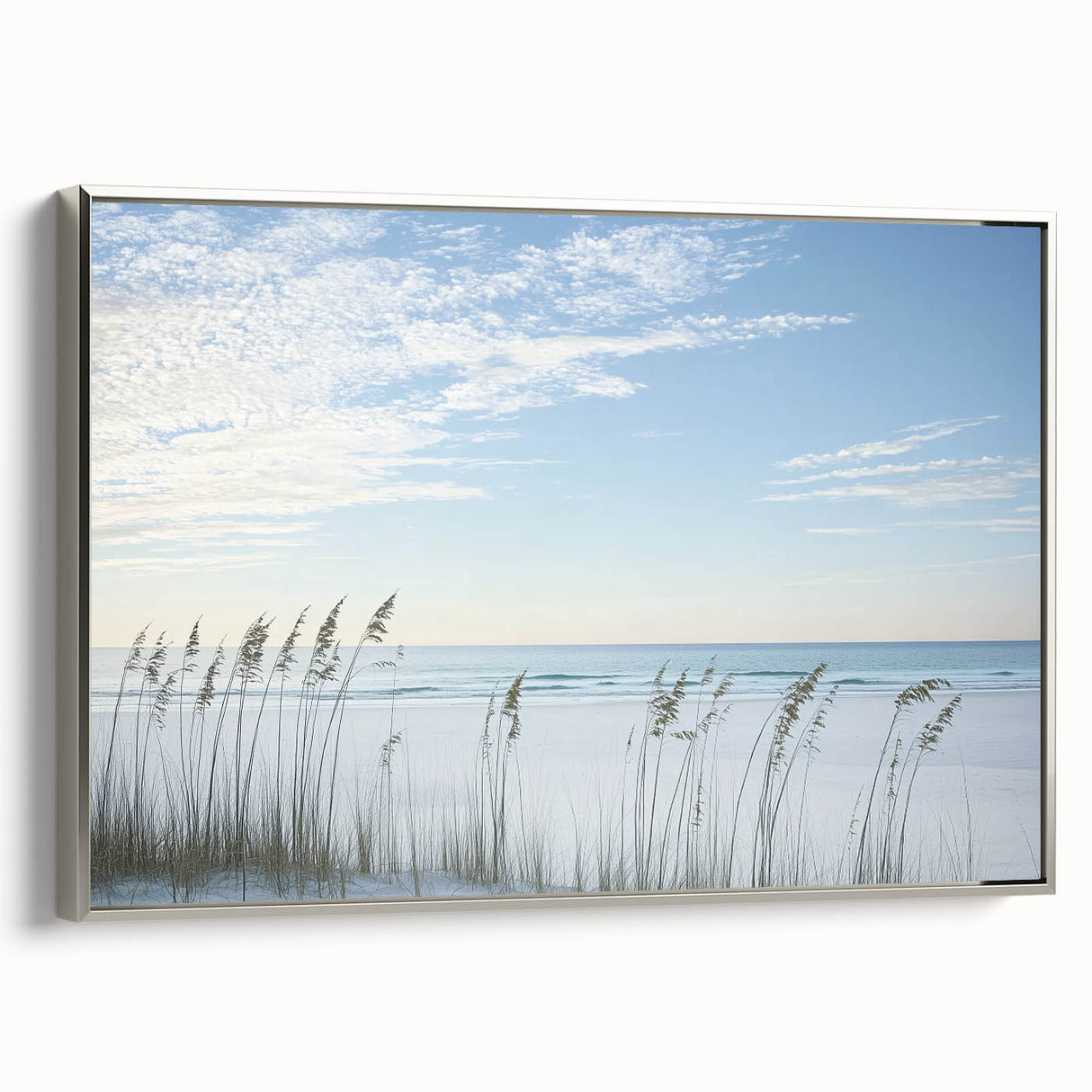 Framed landscape canvas depicting a serene beach scene with soft waves and a vibrant sunset, showcasing a silver frame that enhances its elegant appeal. Perfect for coastal-themed decor.