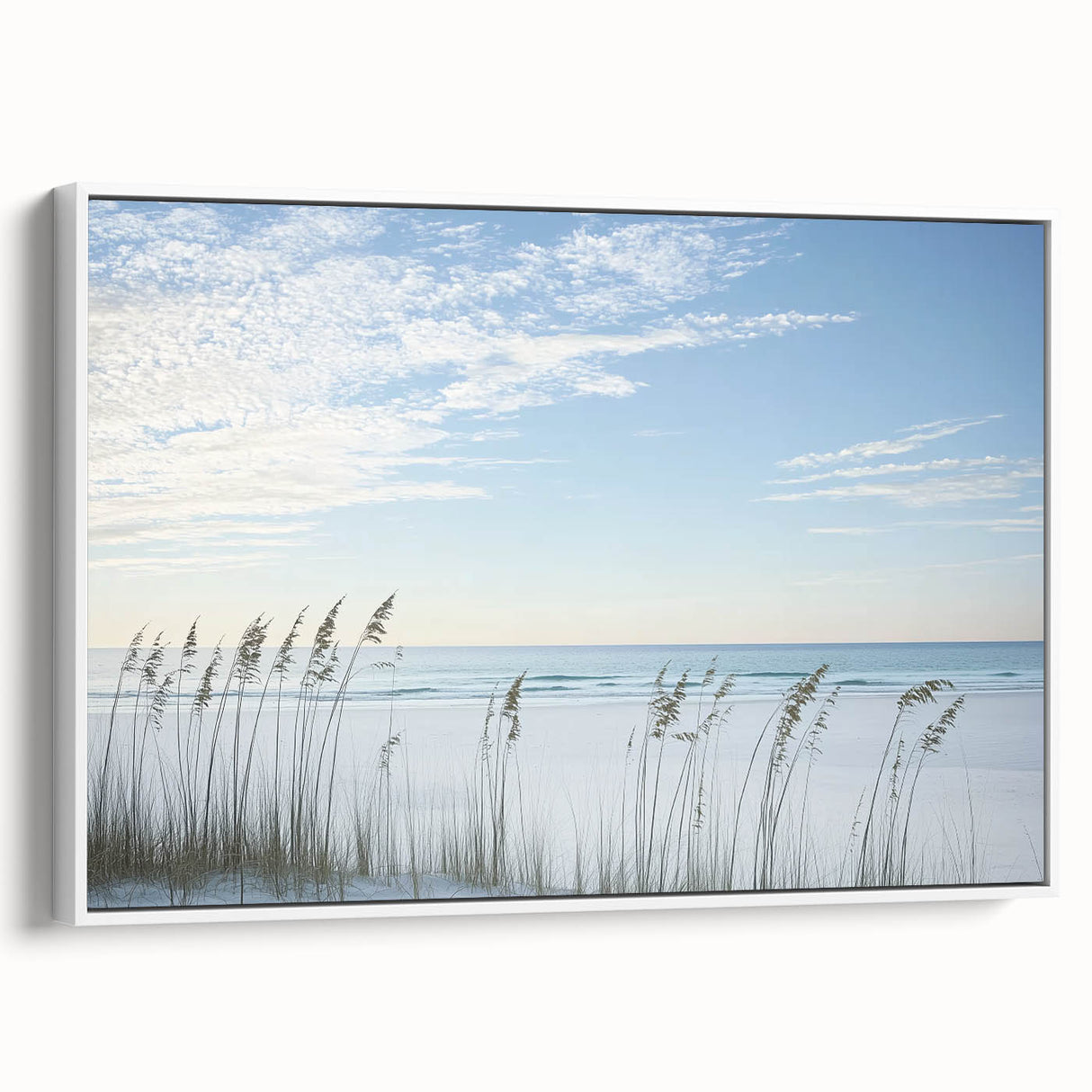 Framed canvas artwork depicting a serene beach landscape with gentle waves and a clear sky, featuring a crisp white frame that enhances its coastal aesthetic.