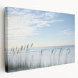 Stretched canvas artwork showcasing a serene beach landscape in vibrant colors, displayed from a side view, ideal for coastal home decor.