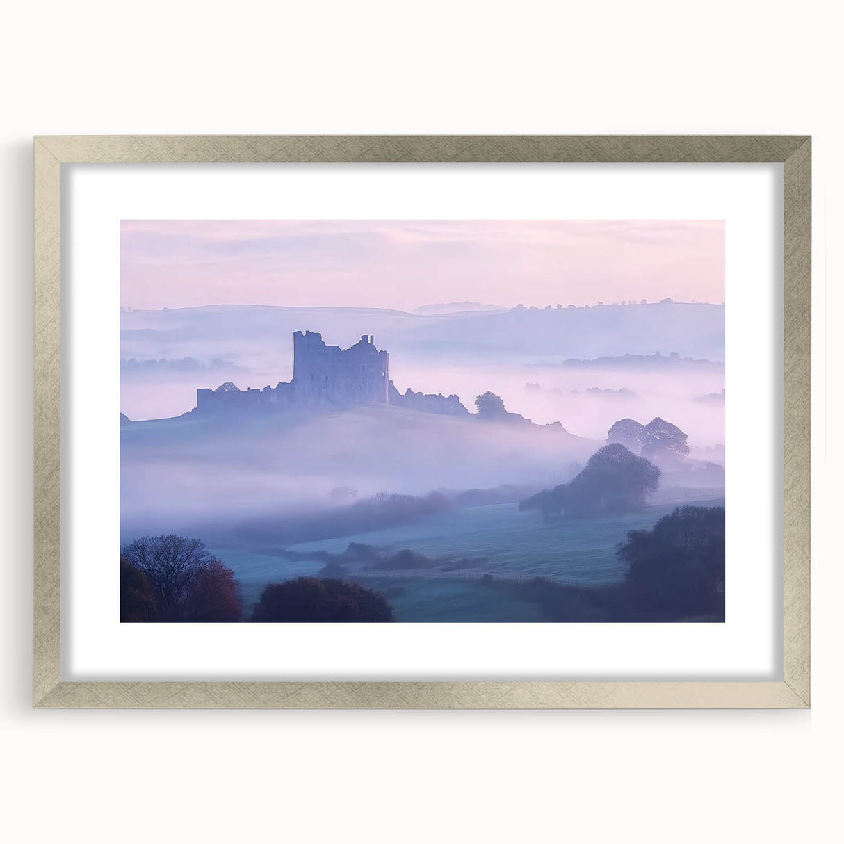 Elegant silver-framed landscape artwork depicting a majestic castle surrounded by lush greenery, presented with a white mat for added sophistication. Perfect for home decor.