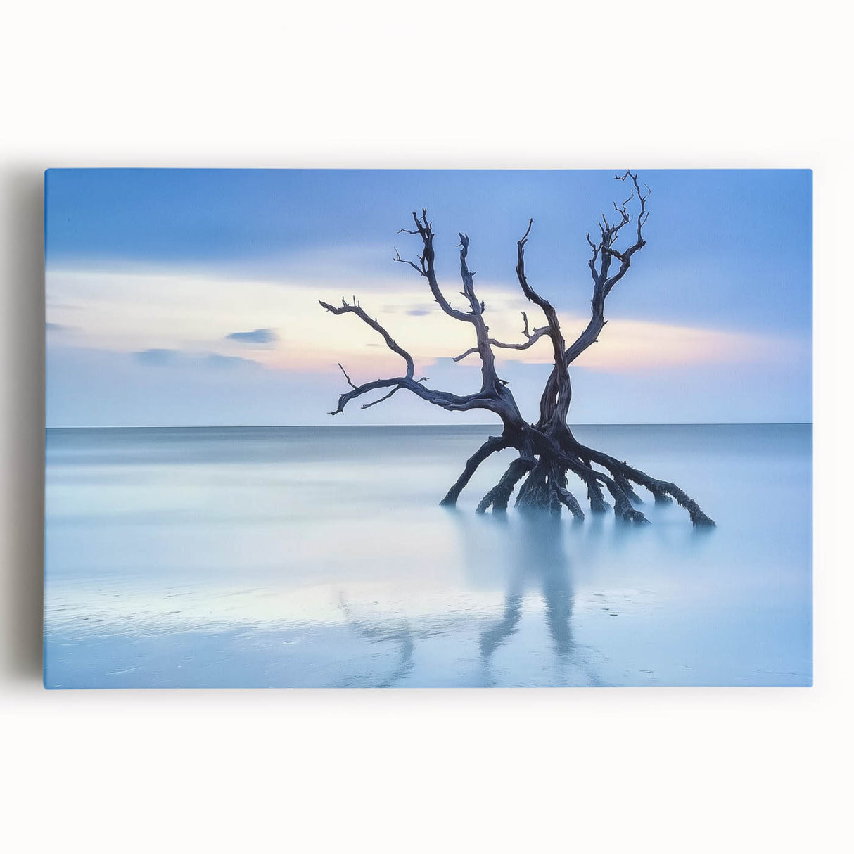 Stretched canvas artwork depicting a serene beach landscape with soft waves and vibrant sunset colors, ideal for coastal home decor and relaxation themes.