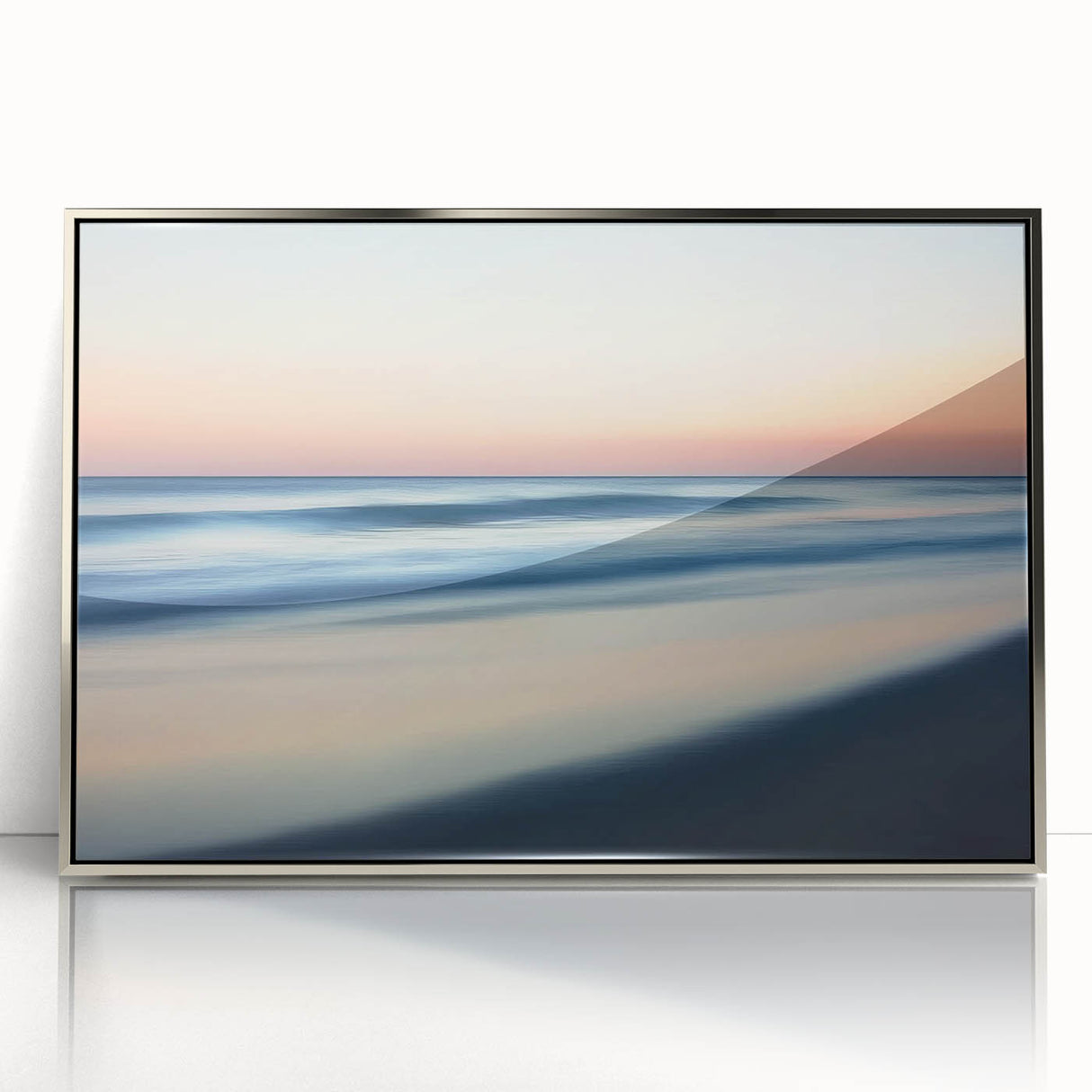 Framed acrylic artwork showcasing a serene beach landscape with soft waves and a vibrant sunset, highlighted by a silver frame, ideal for coastal-themed decor.