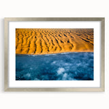 Abstract art print of a Namibian landscape in muted earth tones, framed in silver, suitable for dining room decor.