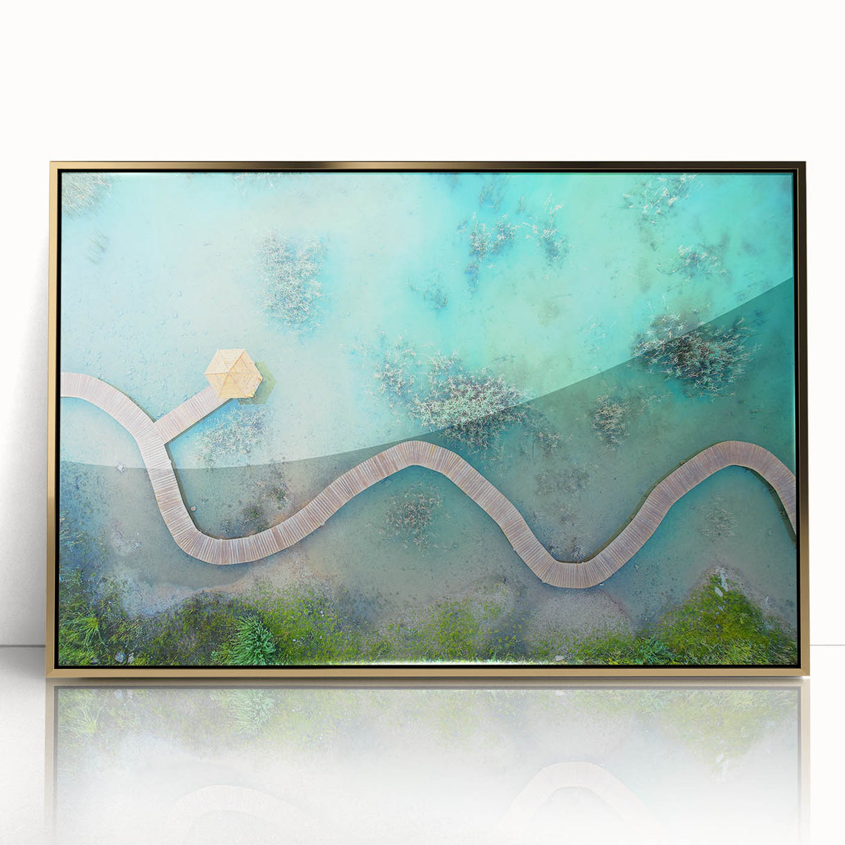 Large art print of a serene Maldives beach scene in muted blue and sandy hues on a framed acrylic.