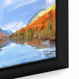 A close-up of a framed canvas featuring a textured, colorful abstract design with black accents.