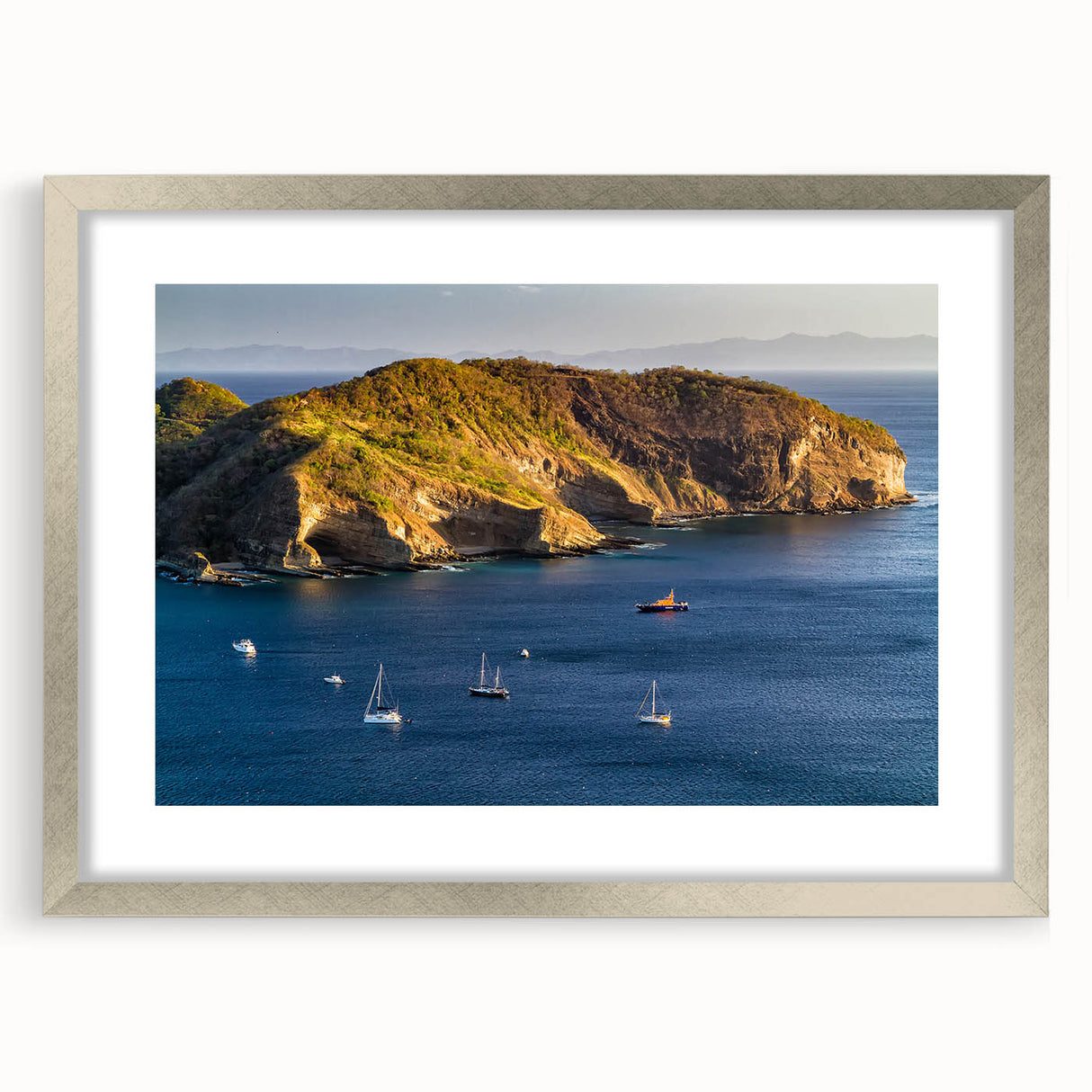 Textured abstract art print of a Nicaraguan landscape in muted earth tones, framed in silver, suitable for bedroom decor.