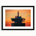 Colorful abstract art print of Amsterdam scenery in vibrant hues, framed in black, ideal for living room decor.