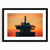 Colorful abstract art print of Amsterdam scenery in vibrant hues, framed in black, ideal for living room decor.