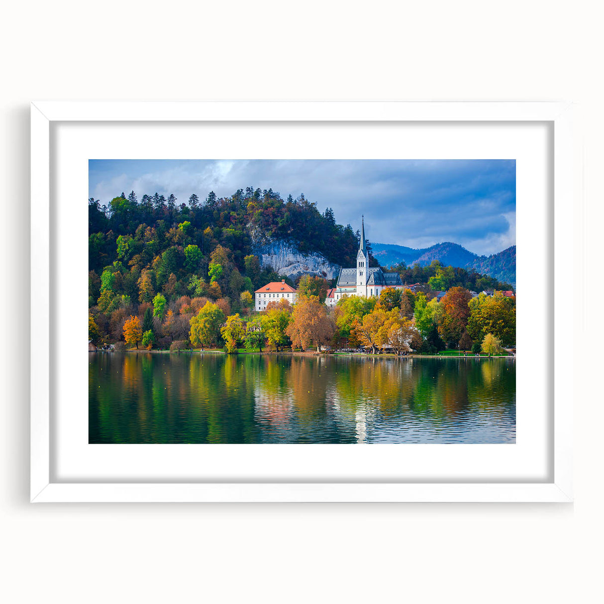 Extra large abstract art print of a Slovenian landscape, in muted green and blue tones on a white framed canvas.