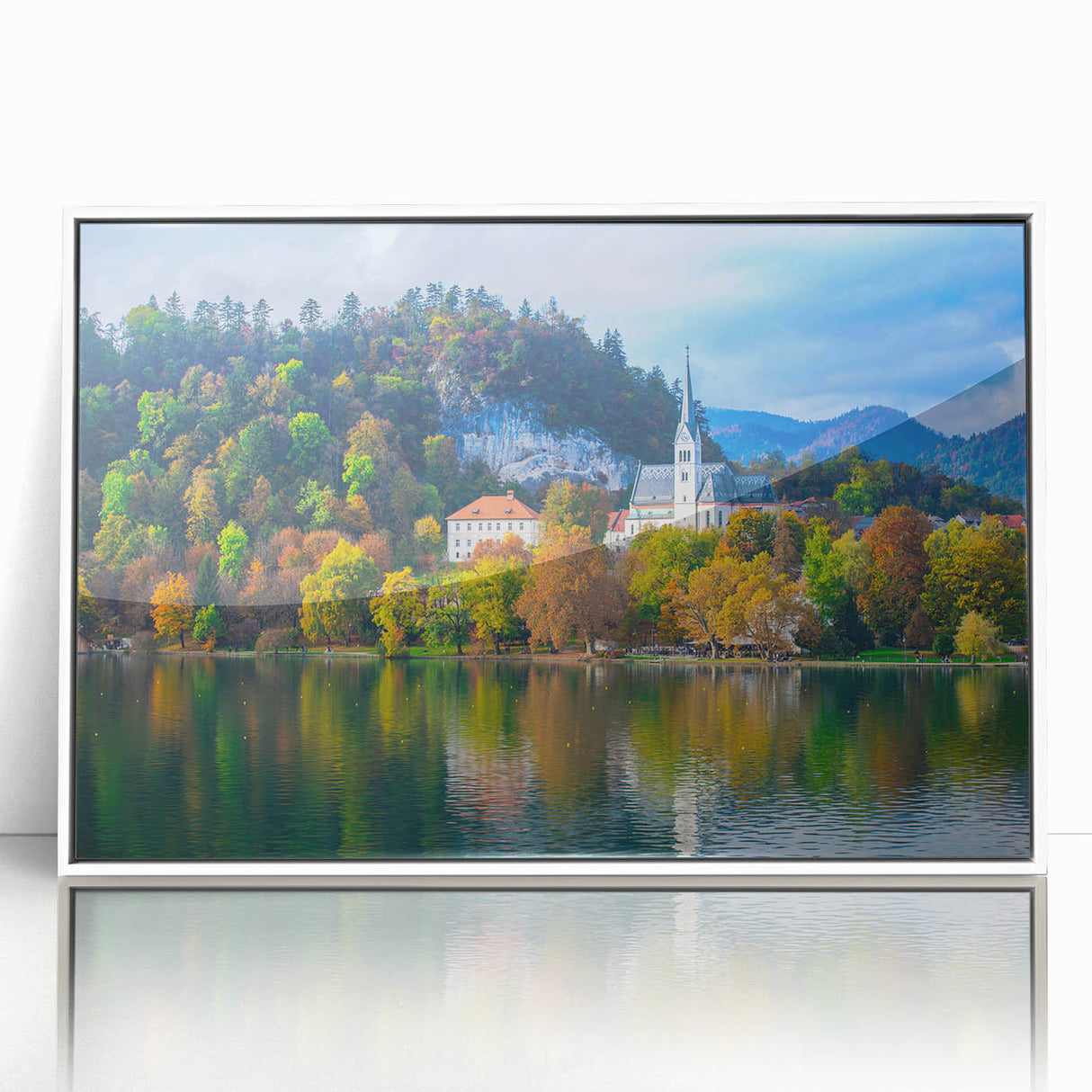 Large art print of a Slovenian landscape in muted green and blue tones on a white-framed acrylic.