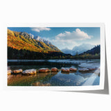 Rolled print of a Swiss landscape featuring lush greenery and distant mountains, in muted earth tones.
