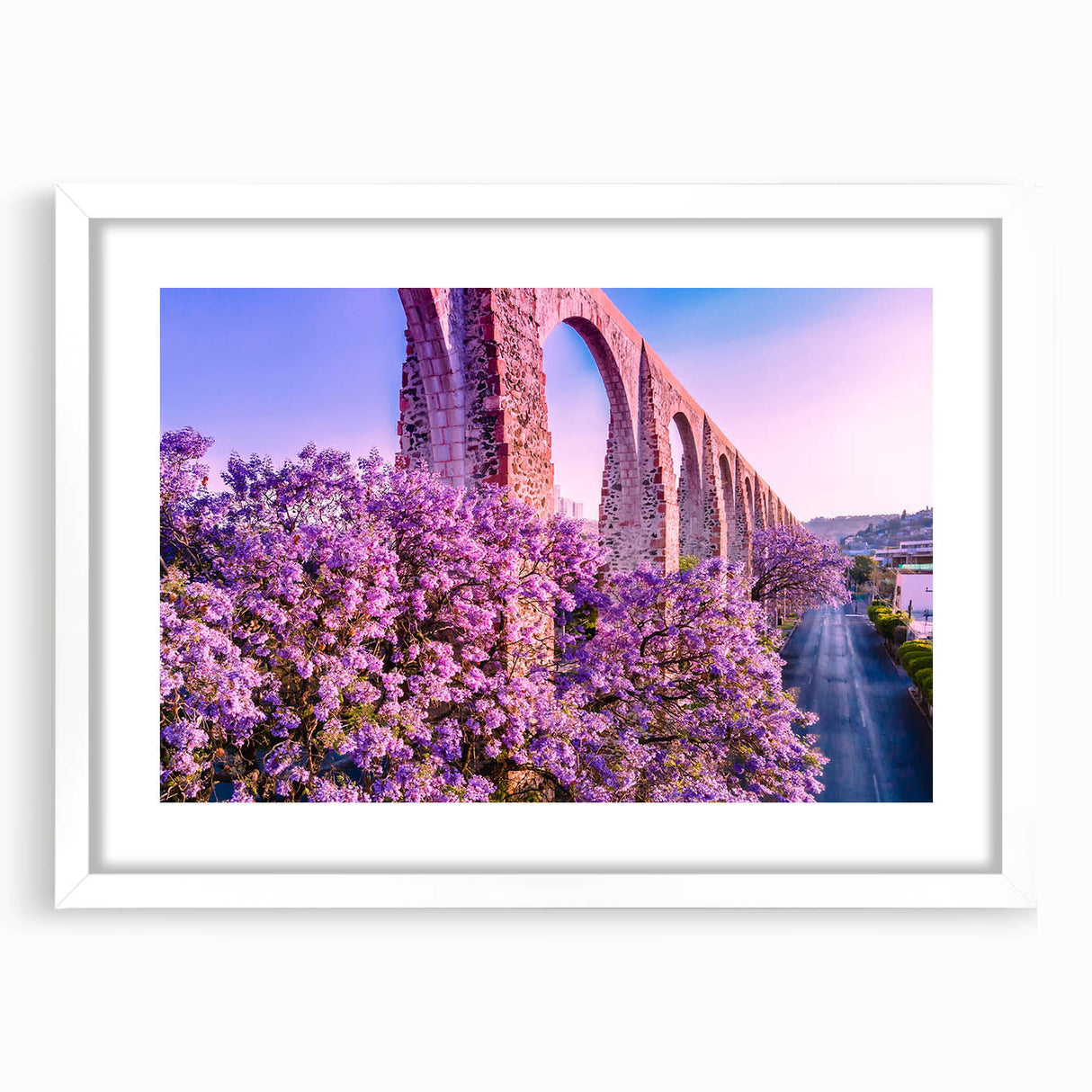 Abstract art print of Guanajuato, Mexico, featuring vibrant multicolored buildings on a framed white mat.