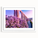 Abstract art print of Guanajuato, Mexico, featuring vibrant multicolored buildings on a framed white mat.