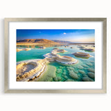 Textured art depicting the Dead Sea with abstract blue and beige tones on a framed silver mat, ideal for bedroom art.