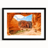 Abstract art print of a Middle Eastern desert scene in vibrant orange and red tones on a large textured canvas.