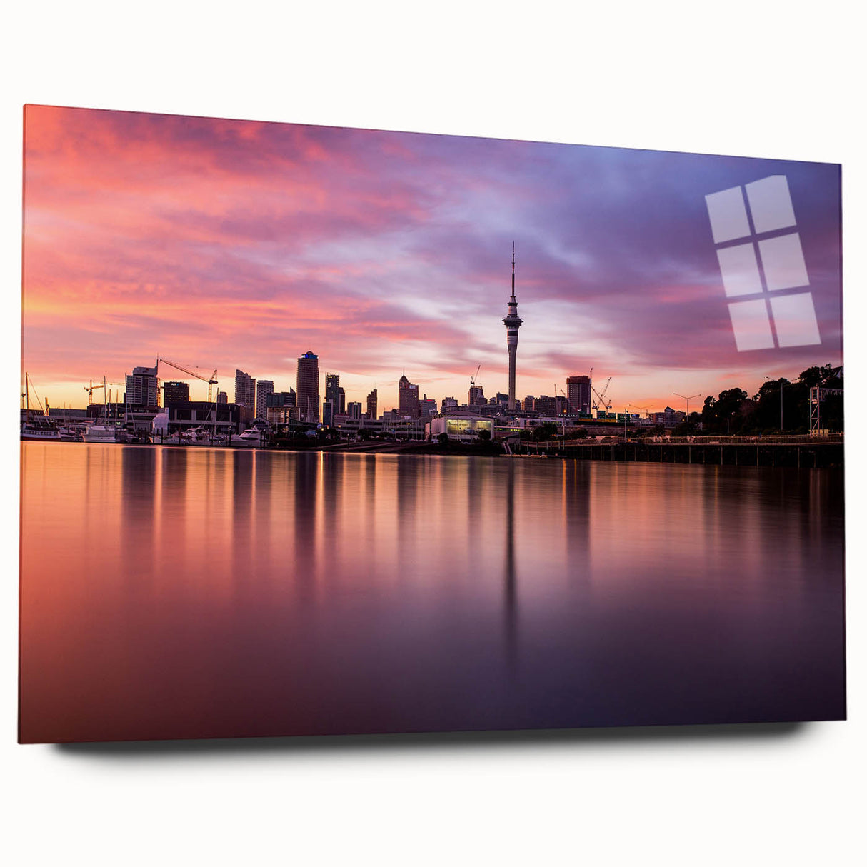 Large abstract wall art depicting Auckland's skyline in muted gray and blue tones on acrylic glass.