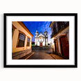 Colorful abstract art print of a textured South American scenery in a large black frame, suitable for living room decor.