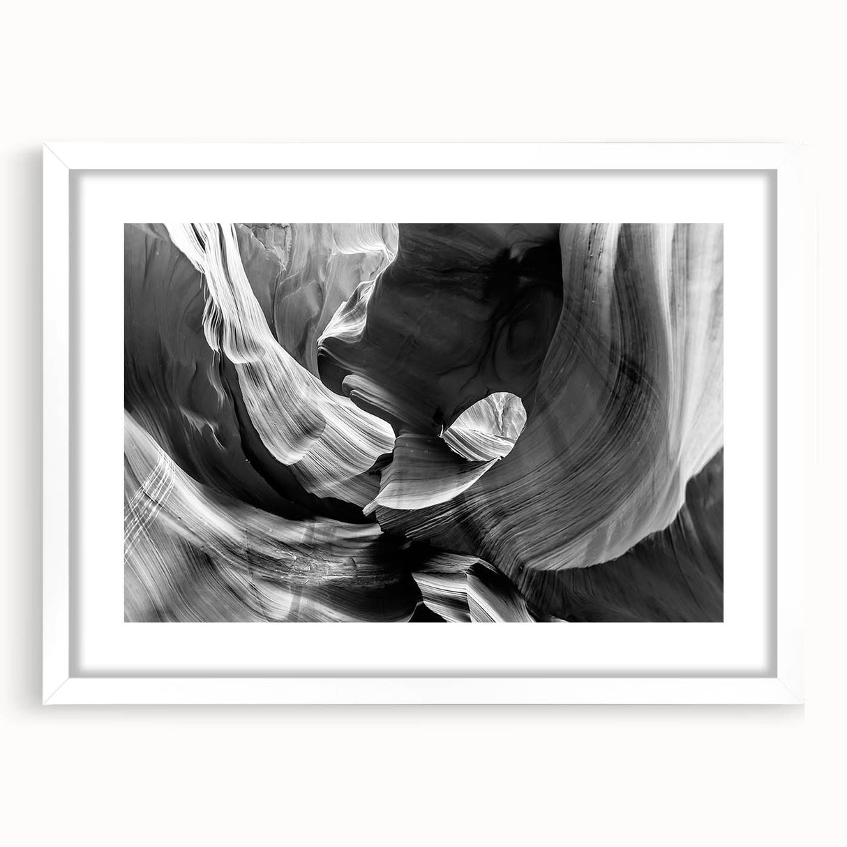 Abstract art print of Antelope Canyon in Arizona, featuring swirling orange and red rock formations, framed in white.