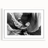 Abstract art print of Antelope Canyon in Arizona, featuring swirling orange and red rock formations, framed in white.