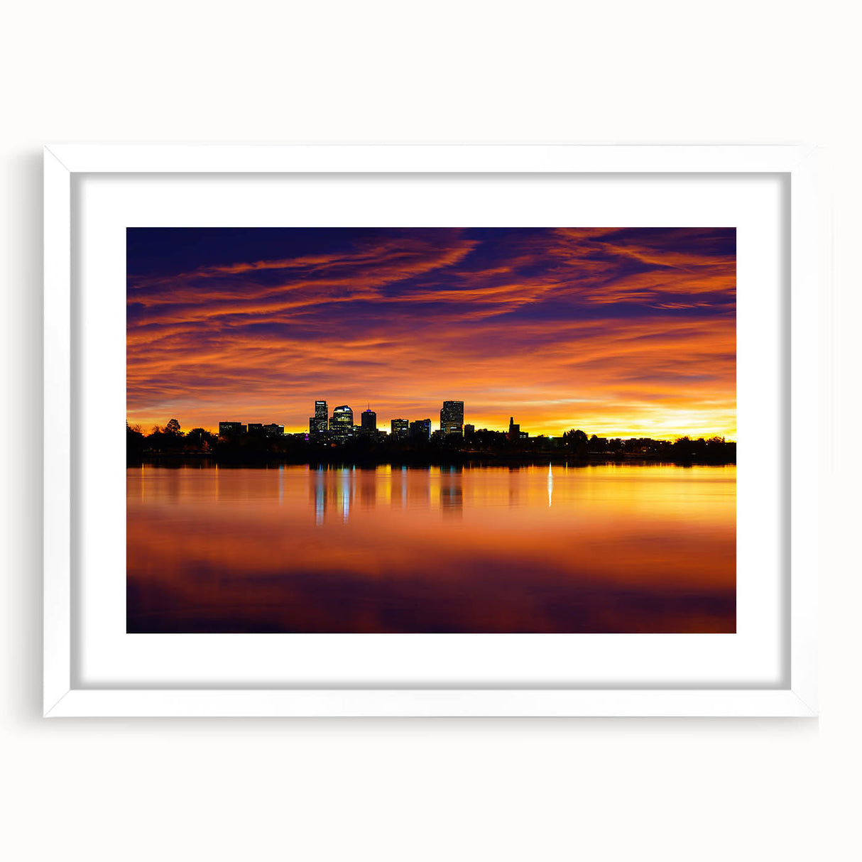 Abstract art print of Denver scenery in muted blue and green tones on a framed white mat, suitable for dining room decor.