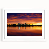 Abstract art print of Denver scenery in muted blue and green tones on a framed white mat, suitable for dining room decor.