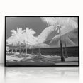Large abstract wall art depicting the Florida Keys in muted blue and green tones, framed in black acrylic.