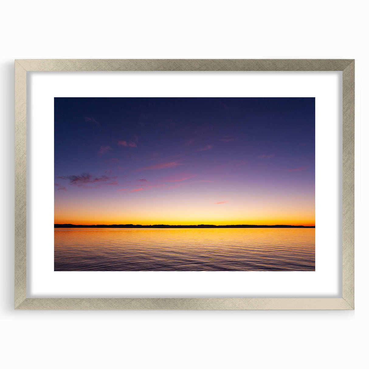 Textured art print of Lake Michigan in muted blue tones, framed in silver, ideal for bedroom wall decor.