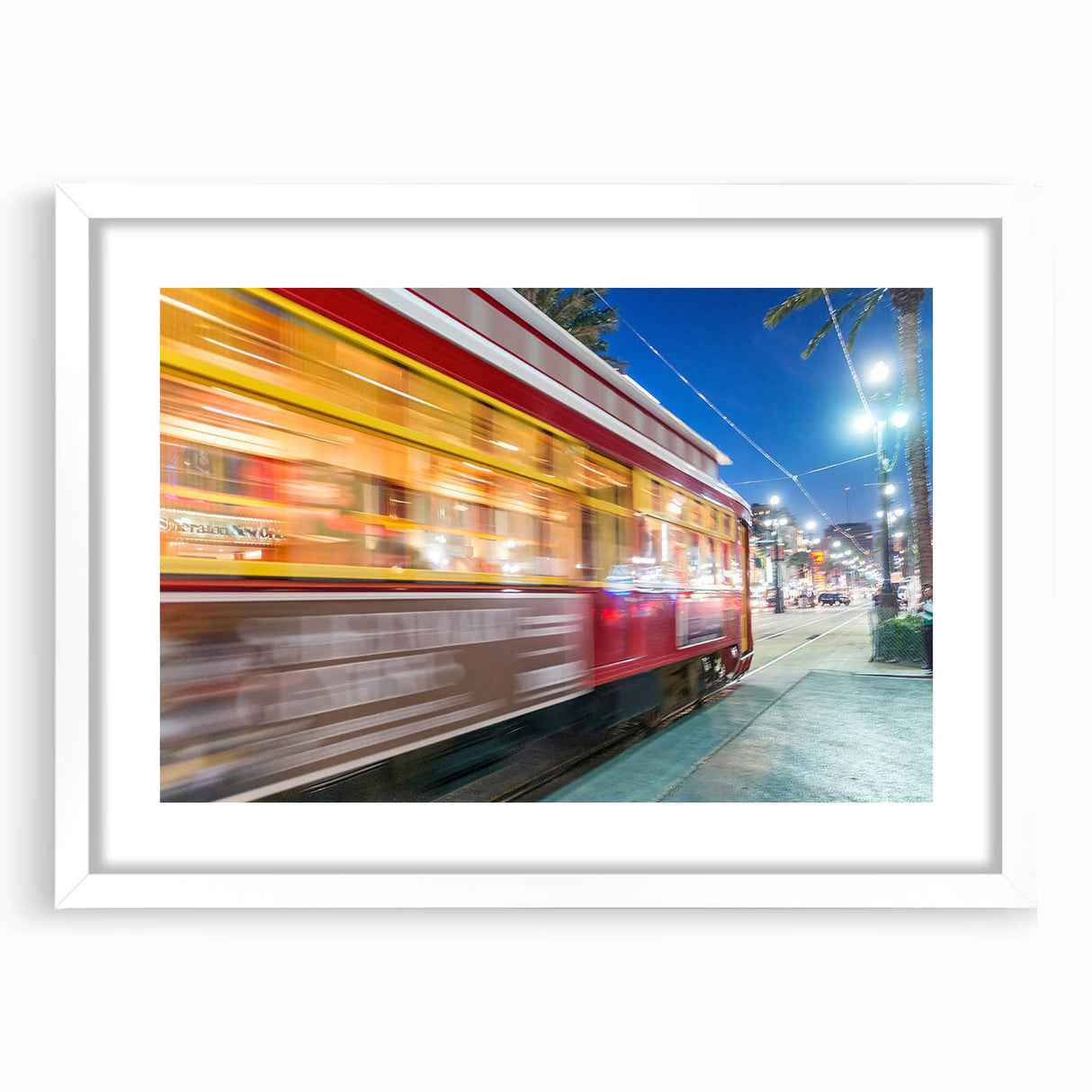 Abstract art print of New Orleans scenery in muted green and blue tones, framed with a white mat.