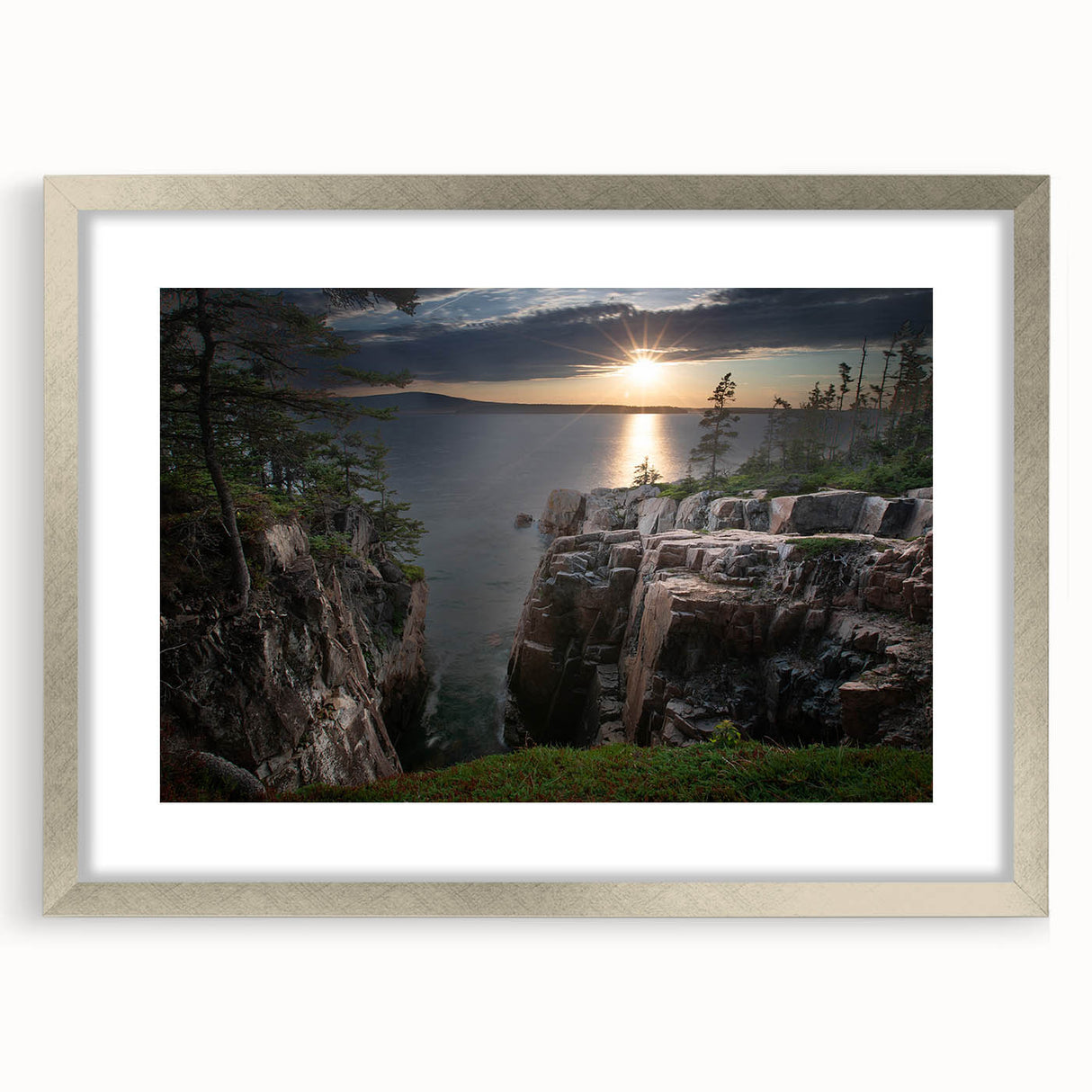 Textured abstract art print depicting Acadia's rugged coastline in muted blue and gray tones, framed in silver.