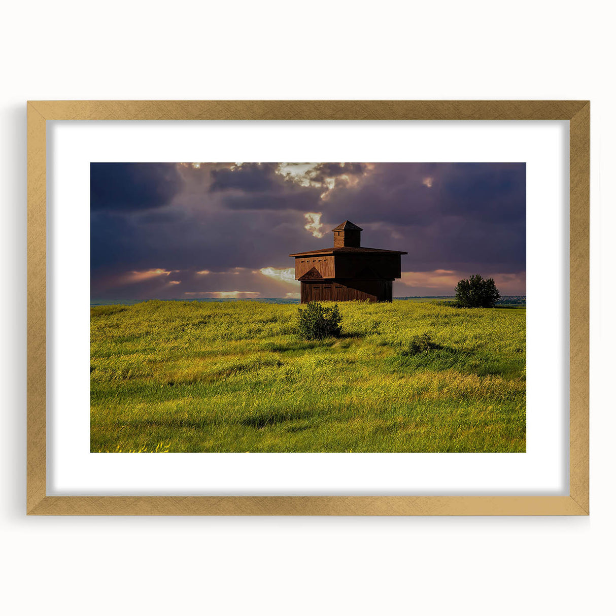 Extra large abstract art print of North Dakota scenery in muted earth tones on a textured canvas, framed in gold.