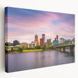 Side view of a stretched canvas depicting a serene Portland, Oregon landscape in muted green and blue tones.
