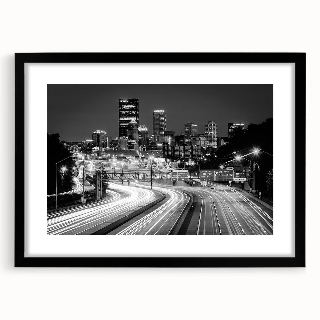 Extra large framed wall art featuring a colorful abstract depiction of the Pittsburgh skyline, ideal for living room decor.