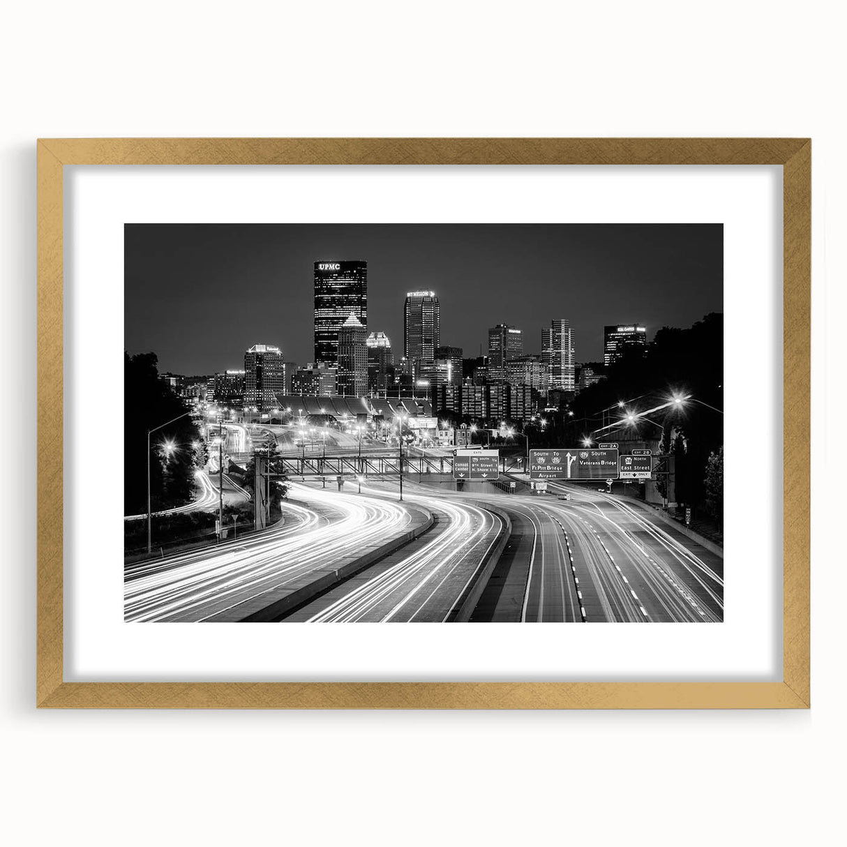 Extra large abstract art print of Pittsburgh skyline in muted gray and gold tones on a framed canvas.