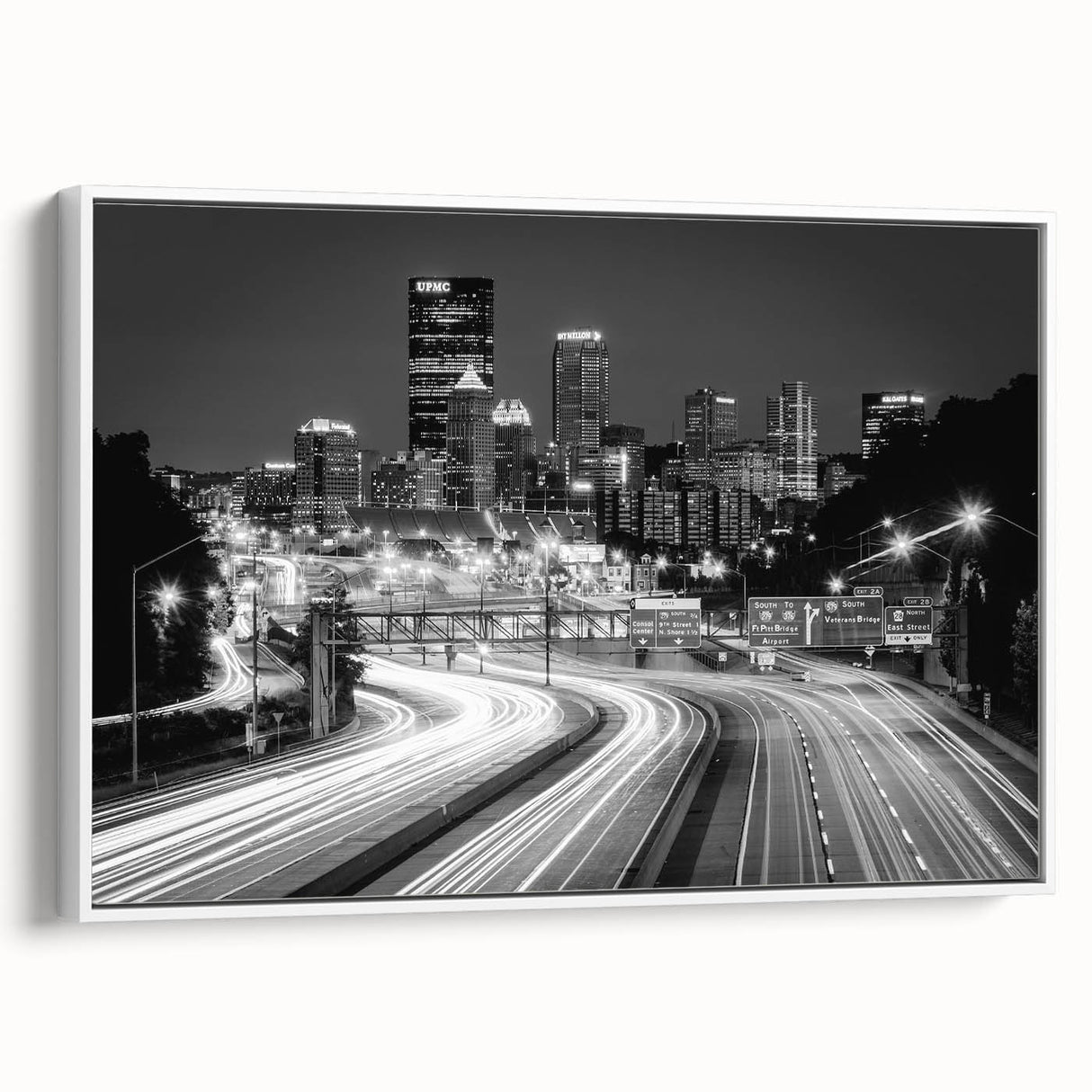 Vintage poster art of Pittsburgh skyline in vibrant colors on a large framed canvas, ideal for living room decor.