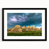 Colorful abstract art print of South Dakota Badlands in a large black frame, ideal for living room decor.