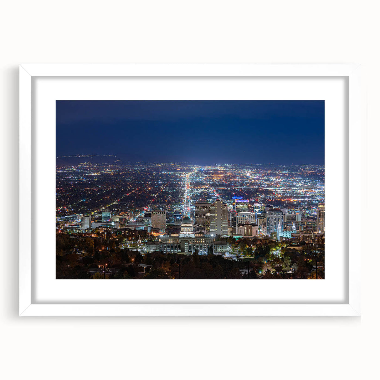 Abstract art print of Salt Lake City with muted blue and green tones on a framed white mat, ideal for dining room decor.