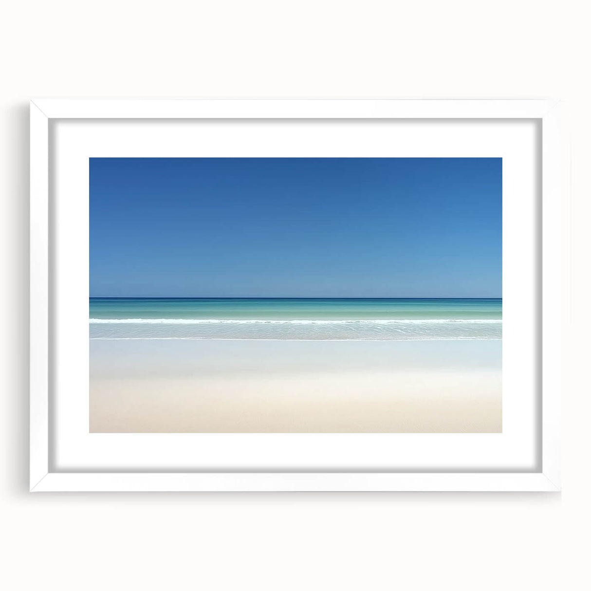 White-framed landscape print showcasing a serene beach scene with gentle waves and golden sand, perfect for coastal home decor. Ideal for enhancing living spaces.
