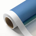 Beautiful rolled canvas artwork depicting a serene beach landscape with gentle waves and a clear blue sky, packaged securely in a protective cardboard tube for safe delivery.