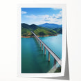 Rolled print of a decorative landscape bridge design showcasing vibrant colors and intricate details, securely housed in a protective cardboard tube for easy transport.