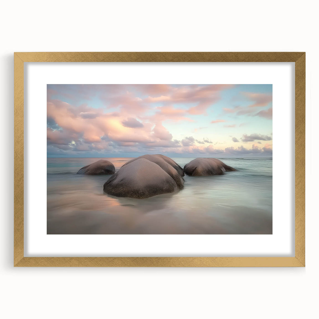 Gold-framed landscape artwork depicting serene beaches, elegantly matted for a polished look, perfect for enhancing home decor with a coastal theme.