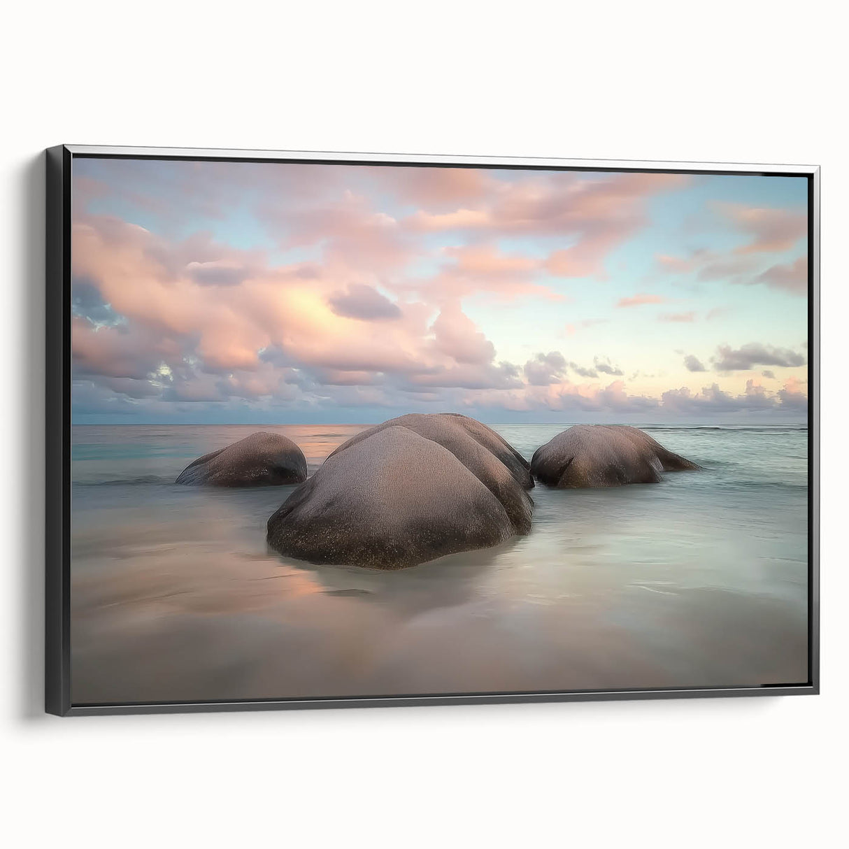 Framed canvas artwork depicting a serene beach landscape with vibrant colors and calming waves, showcasing a sleek black frame from a side view, perfect for home decor.