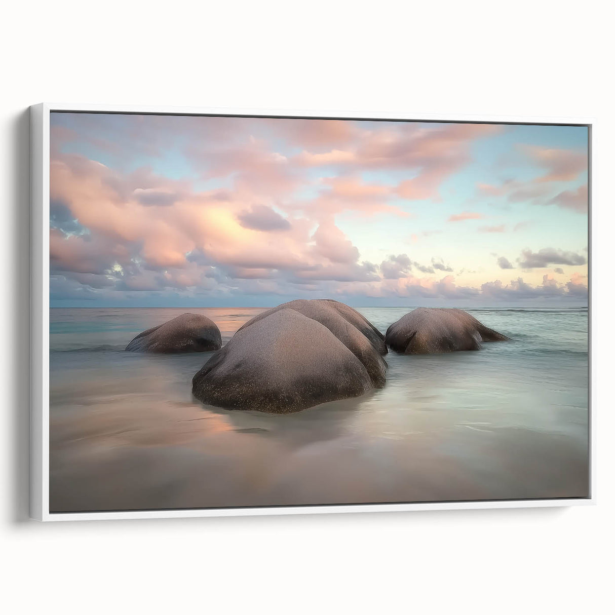 Framed canvas artwork showcasing a serene beach landscape, featuring soft waves and a vibrant sunset, presented in a sleek white frame, perfect for coastal decor.